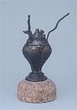 花瓶のような形の銅色の作品の写真