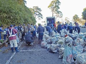 唐沢山城跡むかで(ゴミ)退治で清掃作業をしている町民の方々とごみが入った大量のごみ袋の写真