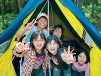 テントの入口から笑顔でピースをしている5人の女の子の写真